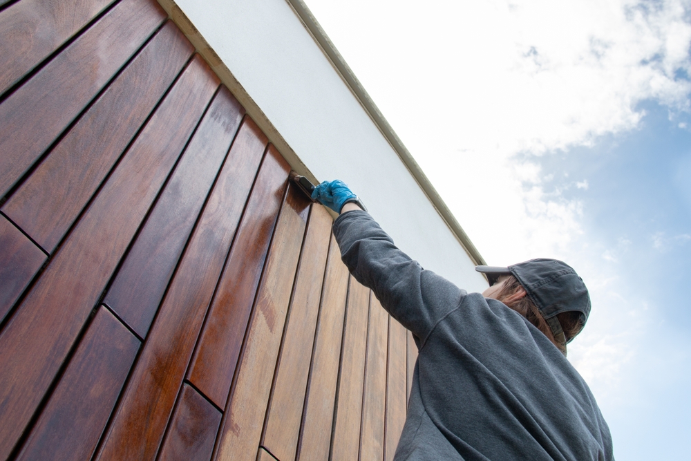 Staining,The,Wood,Facade,Cladding,With,Paint,Brush,And,Protective